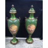 A pair of large continental vases with covers decorated with Ormolu handles and raised gilt work.