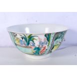A Chinese porcelain Famille Verte bowl decorated with figures in panels 8 x 16cm.