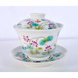 A Chinese porcelain Famille Verte tea bowl with stand and lid decorated with foliage and waterfall 1