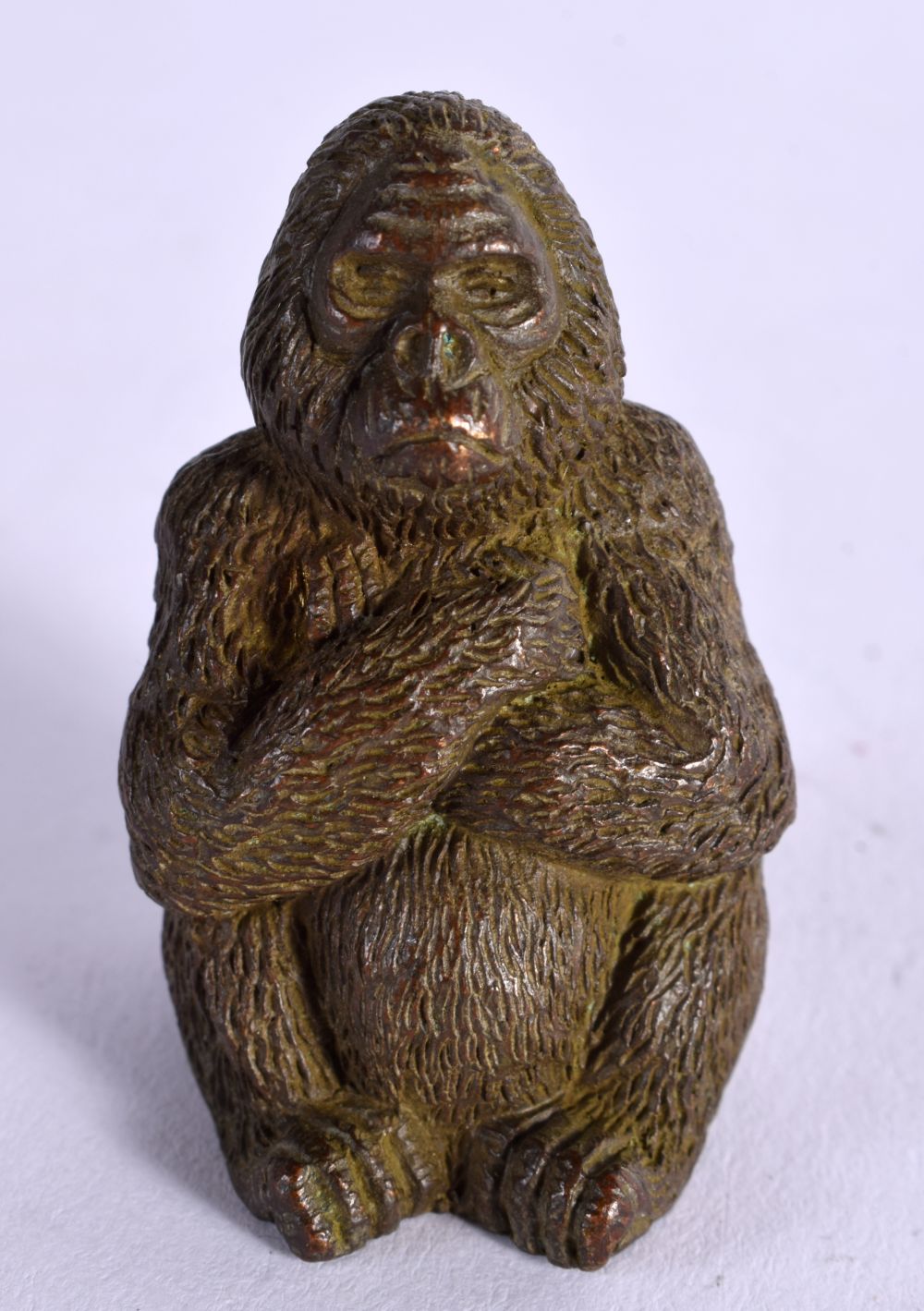 A BRONZE OF A SEATED GORILLA. 4.6cm x 3cm X 2.8cm, weight 127g