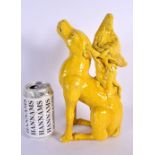 A LARGE 19TH CENTURY EUROPEAN YELLOW GLAZED FIGURE OF A BEAST modelled with a female immortal upon i