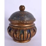 AN INDIAN POLYCHROMED WOODEN BOX AND COVER painted with foliage. 16 cm x 8 cm.