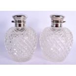 A PAIR OF ANTIQUE SILVER TOPPED CUT GLASS SCENT BOTTLES AND STOPPERS. Sheffield 1911. 1037 grams ove