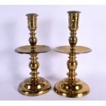 A PAIR OF 18TH CENTURY EUROPEAN BRONZE CANDLESTICKS with circular drip pans. 25 cm high.