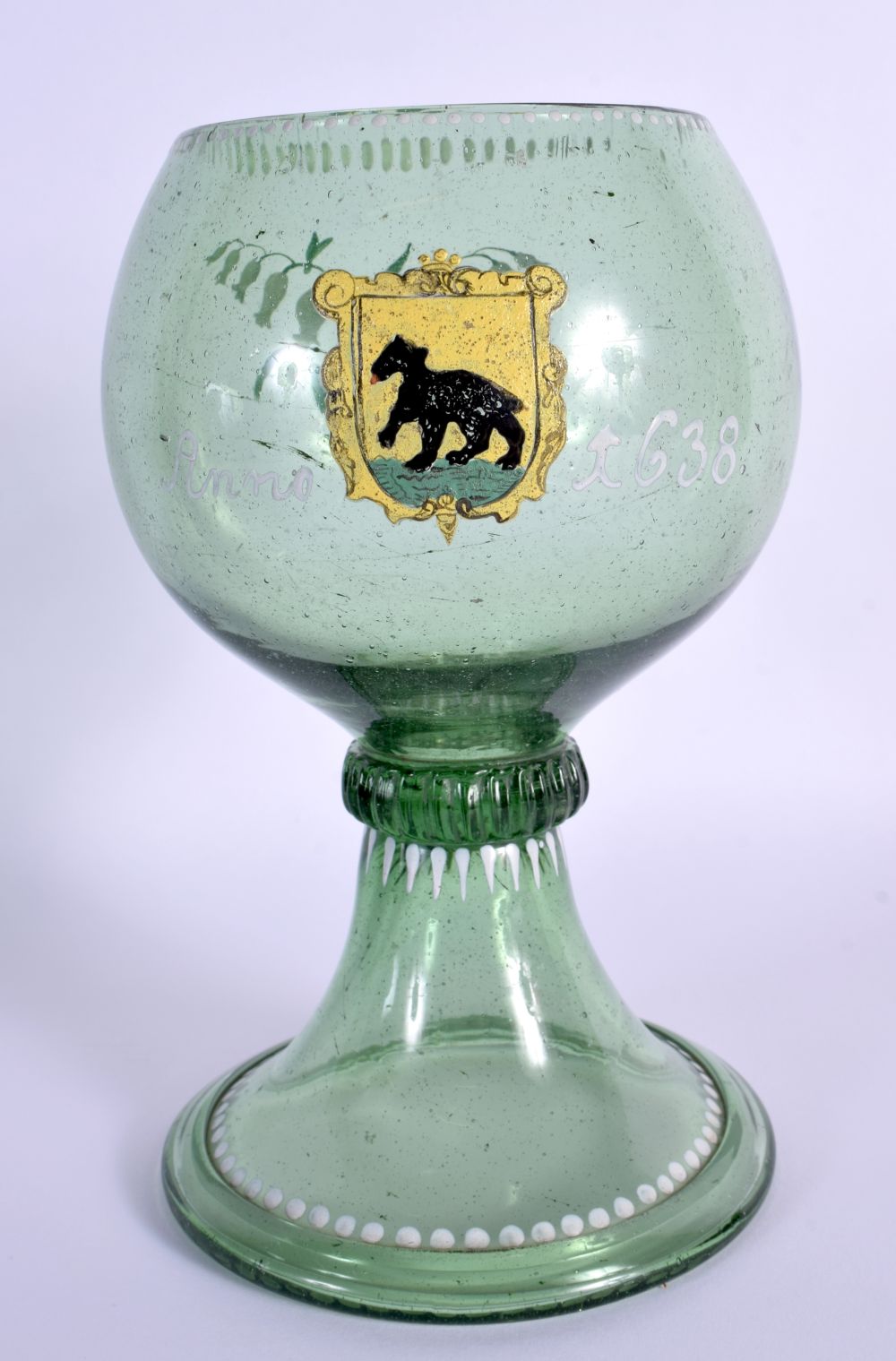 A 19TH CENTURY GERMAN GREEN GLAZED ARMORIAL GOBLET painted with a black bear, dated 1638. 20 cm x 10