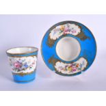 18TH CENTURY SEVRES TREMBLEUSE CUP AND SAUCER PAINTED WITH FLOWERS IN GILDED CARTOUCHES ON A TURQUOI