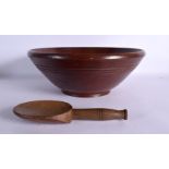 A VINTAGE TREEN BOWL and butter pat. Largest 32 cm diameter. (2)