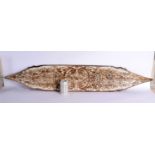 A LARGE VINTAGE TRIBAL CARVED WOOD SHIELD possibly Dayak. 130 cm x 24 cm.