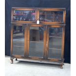 A Mid Century wooden and glass fronted book shelf 115 x 104 x 32 .