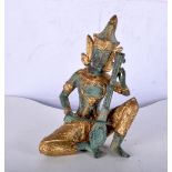 A small South East Asian bronze musician with gilt decoration. 14cm.