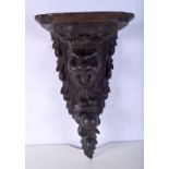 A late 19th Century carved wood lions head shelf. 53 x 30cm.
