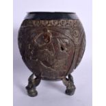 A MID 19TH CENTURY INDIAN CARVED COCONUT AND WHITE METAL CENSER decorated with figures and foliage.