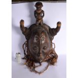 A LARGE EARLY 20TH CENTURY AFRICAN TRIBAL CARVED HARDWOOD MASK with attendant finial. 74 cm x 46 cm.