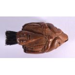 A 19TH CENTURY FRENCH CARVED COQUILLA NUT SNUFF BOX formed as a male with hair. 7.5 cm x 4 cm.