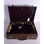 A VINTAGE LEATHER TRAVELLING DRESSING CASE with white metal fittings & two ivorine items. Box 46 cm