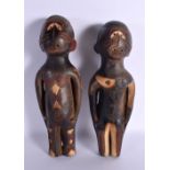 A PAIR OF AFRICAN TRIBAL POLYCHROMED TERRACOTTA FIGURES decorated with motifs. 32 cm high.