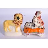 TWO 19TH CENTURY STAFFORDSHIRE FIGURES depicting a lion and spaniels. Largest 8 cm x 9.5 cm. (2)