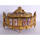 A MID 19TH CENTURY ENGLISH ORMOLU JEWELLERY CASKET enamelled with crests and figures, retailed by Ho