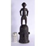 A LARGE EARLY 20TH CENTURY AFRICAN BRONZE TRIBAL BENIN TYPE FIGURE modelled standing upon a mask. 48