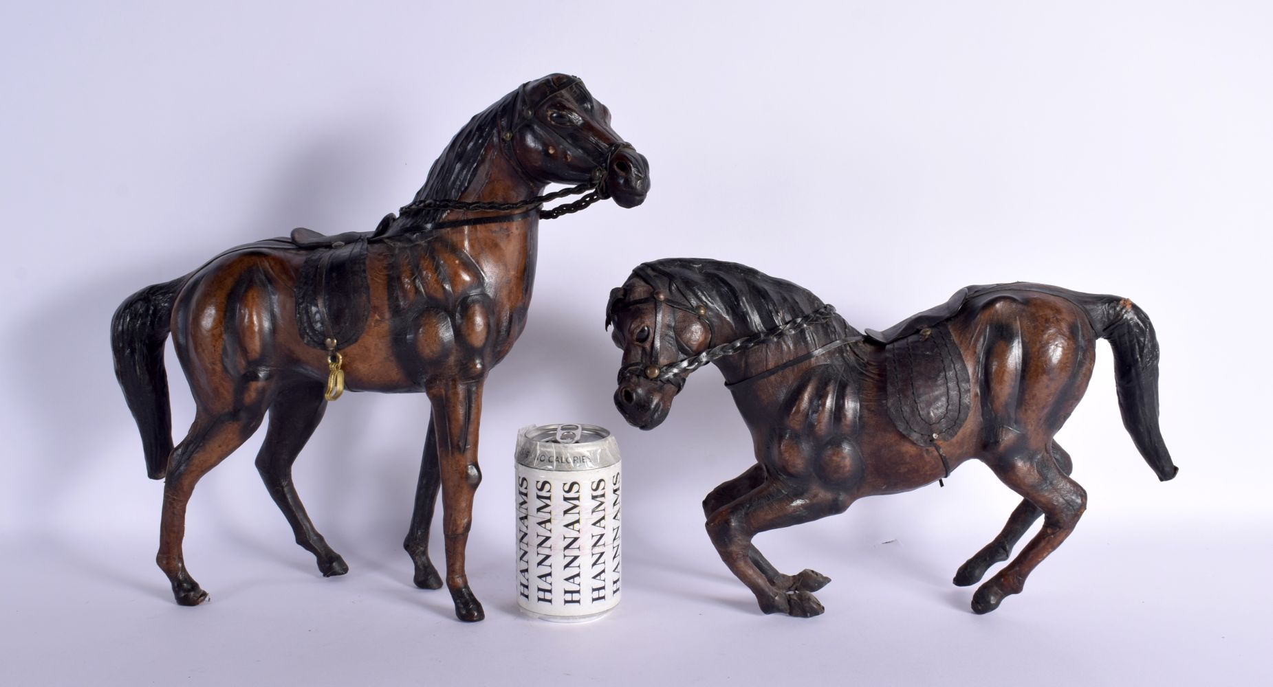 A PAIR OF VINTAGE LEATHER COUNTRY HOUSE HORSES. Largest 33 cm x 27 cm.