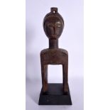AN AFRICAN TRIBAL CARVED WOOD PULLEY. 24 cm high.