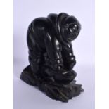 A RARE 19TH CENTURY NORTH WEST COAST HAIDA ARGILLITE TRIBAL FIGURE modelled as a male hunting a whal