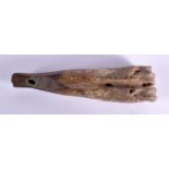 A CHARMING PREHISTORIC FOSSILISED BONE CARVING of almost whale like form. 15 cm wide.