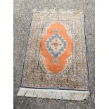 A small Ivory ground Persian rug 139 x 90 cm.