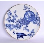 A LARGE AESTHETIC MOVEMENT BLUE AND WHITE DISH decorated with birds. 32 cm diameter.