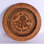 AN ANTIQUE CONTINENTAL CARVED WOOD BUTTER STAMP. 25 cm diameter.