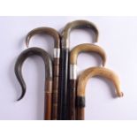 A SET OF FIVE 19TH CENTURY MIDDLE EASTERN CARVED RHINOCEROS HORN WALKING CANES three with silver mou