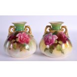 A PAIR OF ROYAL WORCESTER TWIN HANDLED VASES. 9 cm x 7 cm.