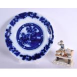 AN ANTIQUE FLOW BLUE PLATE together with an unusual figure of an oyster seller. Largest 21 cm wide.