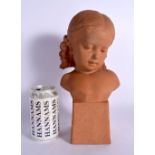 AN ART DECO TERRACOTTA BUST OF A YOUNG FEMALE modelled upon a square plinth. 30 cm x 12 cm.