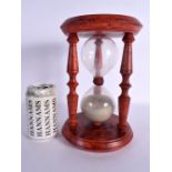 A VINTAGE RED PAINTED CARVED WOOD SAND TIMER. 25 cm x 15 cm.