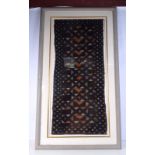 A large framed African Kuba fabric 119 x 57 cm.