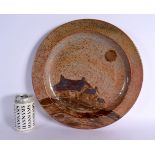 A LARGE STYLISH ENGLISH STUDIO POTTERY CIRCULAR STONEWARE DISH decorated with Chinese landscapes. 36