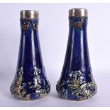 A PAIR OF ANTIQUE SILVER MOUNTED ROYAL DOULTON VASES. 16.5 cm high.