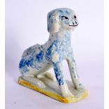 A RARE 18TH CENTURY EUROPEAN FAIENCE TIN GLAZED FIGURE OF A DOG. 9 cm x 10 cm.