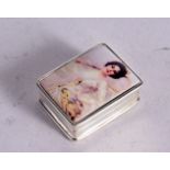 A STERLING SILVER PILL BOX WITH A LADY HOLDING A TENNIS RACKET. Stamped Sterling, 1.3cm x 3.1cm x 2