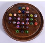 AN ANTIQUE SOLITAIRE MARBLE BOARD with marbles. 24 cm diameter, marbles 2 cm diameter. (qty)