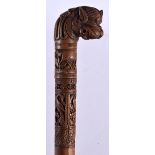 A 19TH CENTURY MIDDLE EASTERN INDIAN BURMESE CARVED WALKING CANE with buddhistic beast terminal. 90