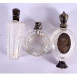 THREE ANTIQUE SILVER TOPPED CRYSTAL GLASS SCENT BOTTLES. Largest 10 cm x 4 cm. (3)