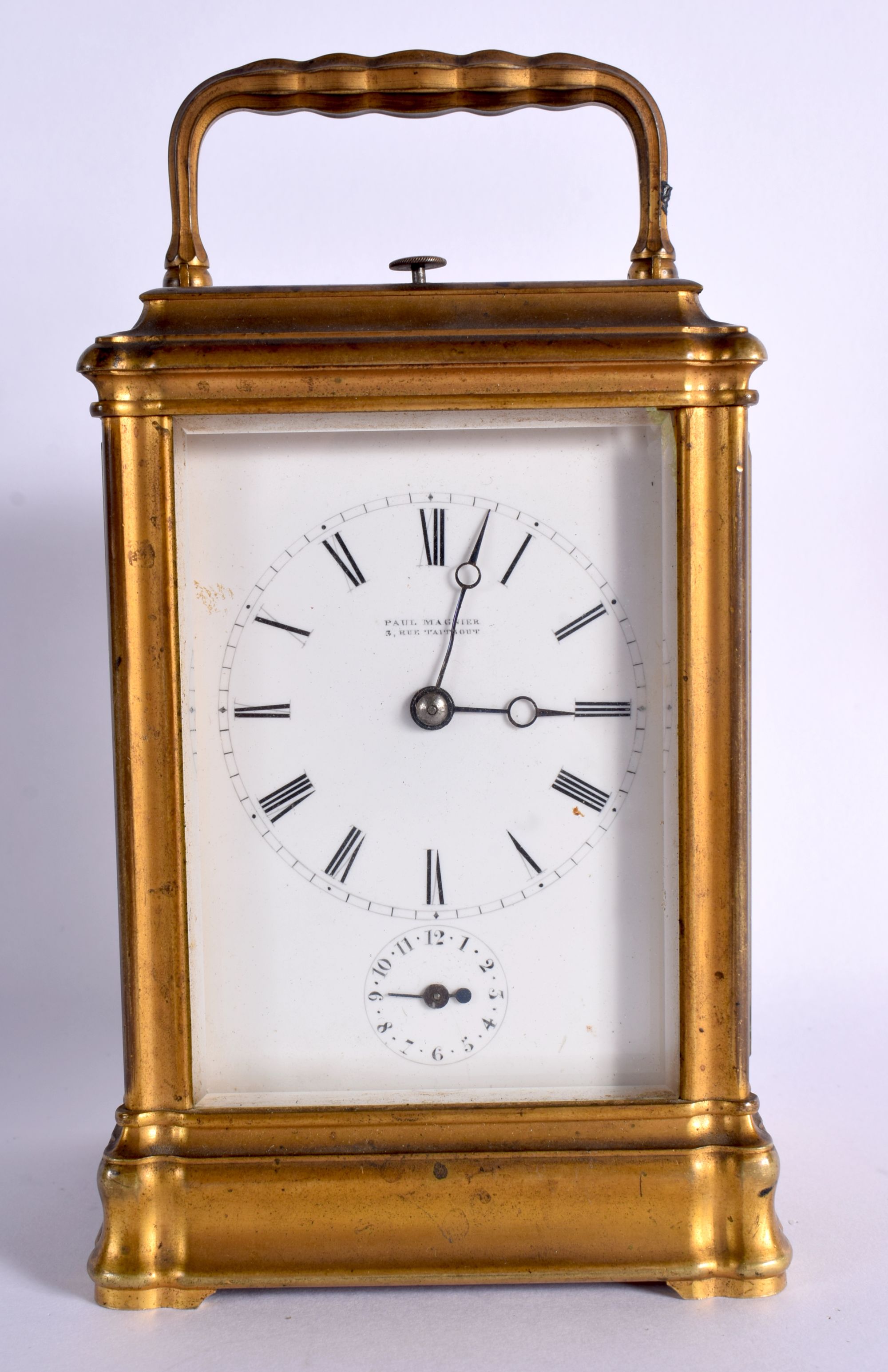 AN ANTIQUE FRENCH BRASS REPEATING CARRIAGE CLOCK retailed by Paul Magnier of Paris, with subsidiary