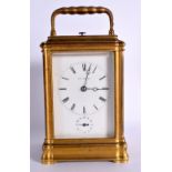 AN ANTIQUE FRENCH BRASS REPEATING CARRIAGE CLOCK retailed by Paul Magnier of Paris, with subsidiary