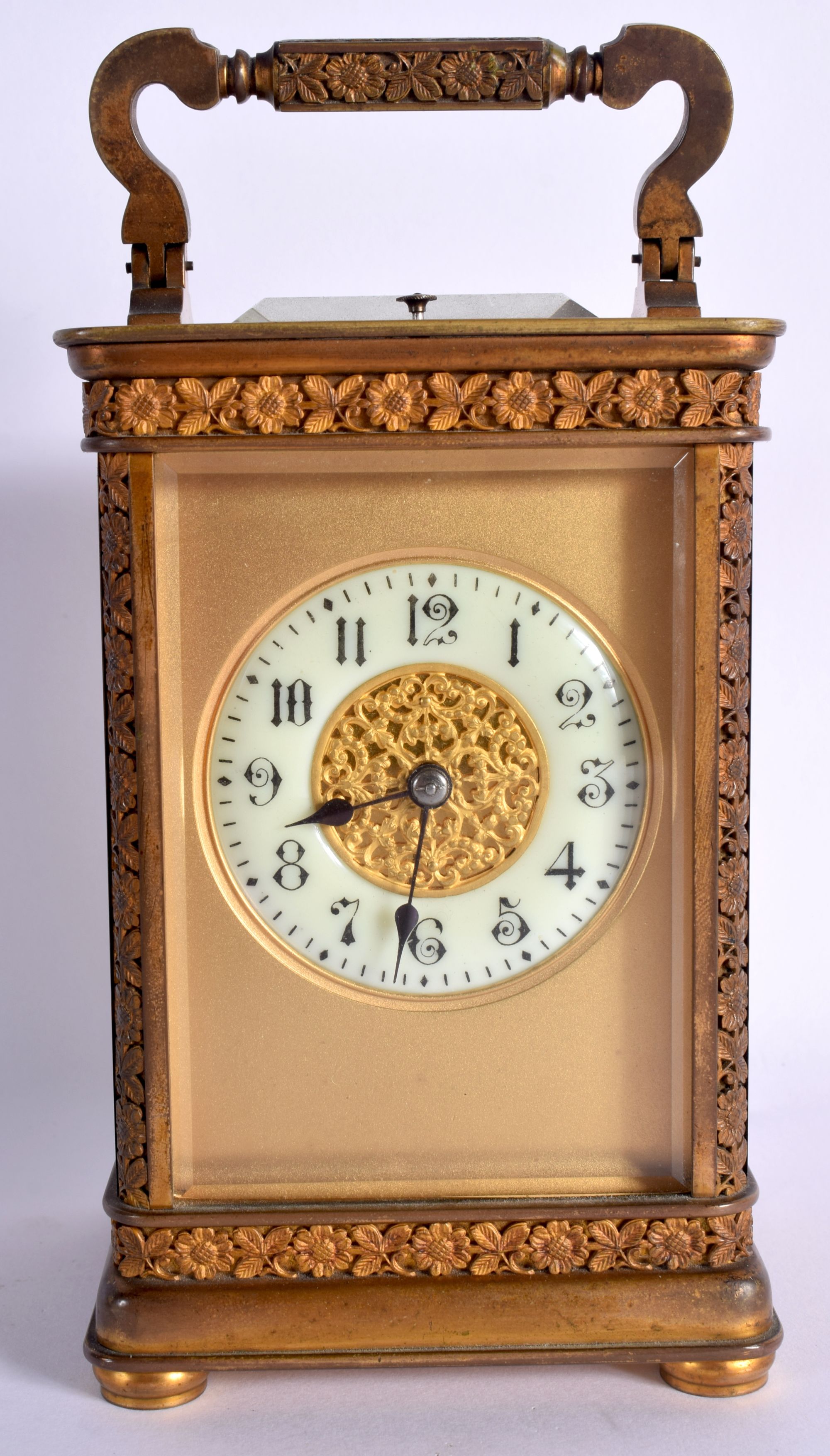 AN ANTIQUE FRENCH BRASS REPEATING CARRIAGE CLOCK with foliate engraved case and handle. 18.5 cm high