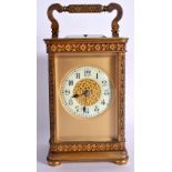 AN ANTIQUE FRENCH BRASS REPEATING CARRIAGE CLOCK with foliate engraved case and handle. 18.5 cm high