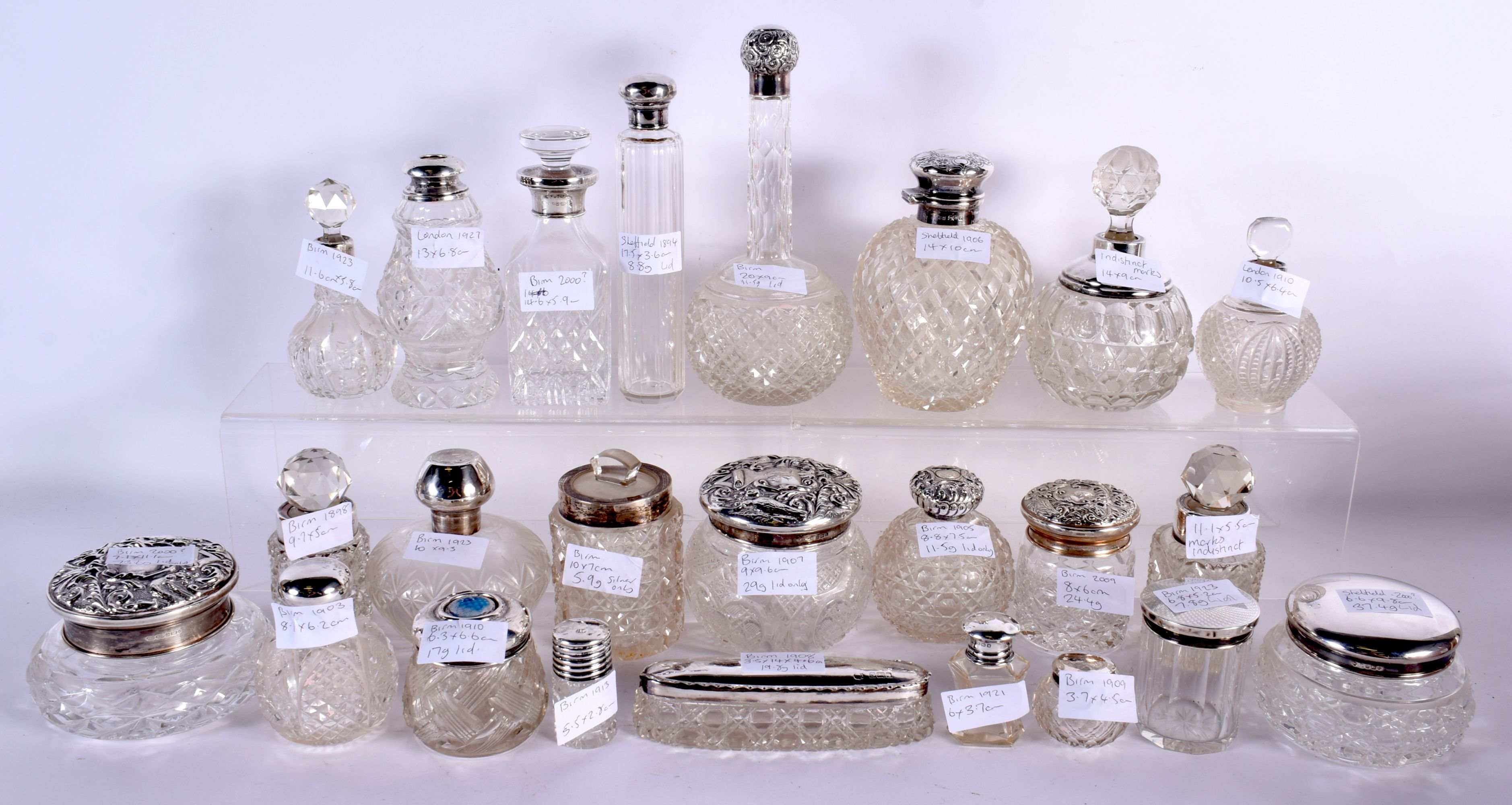 A COLLECTION OF MAINLY ANTIQUE SILVER MOUNTED SCENT BOTTLES in various forms and sizes. Birmingham 1