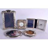 THREE SILVER MOUNTED PHOTOGRAPH FRAMES together with two silver clocks. London 1921, 1970 & 1995. 67