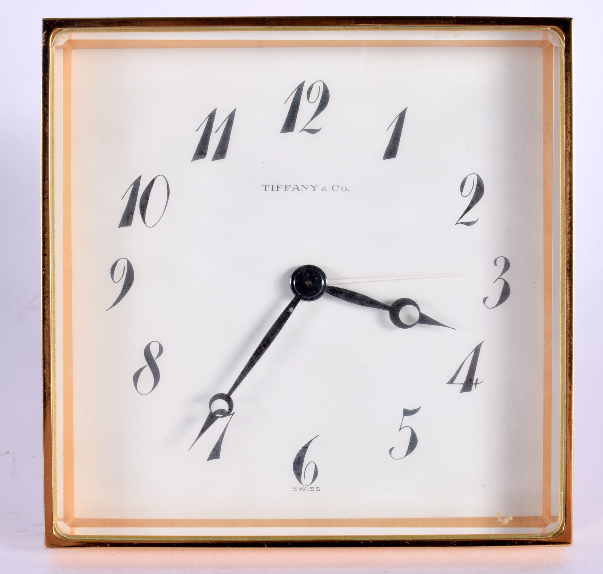 A VINTAGE TIFFANY & CO BRASS DESK CLOCK. 10.5 cm square.